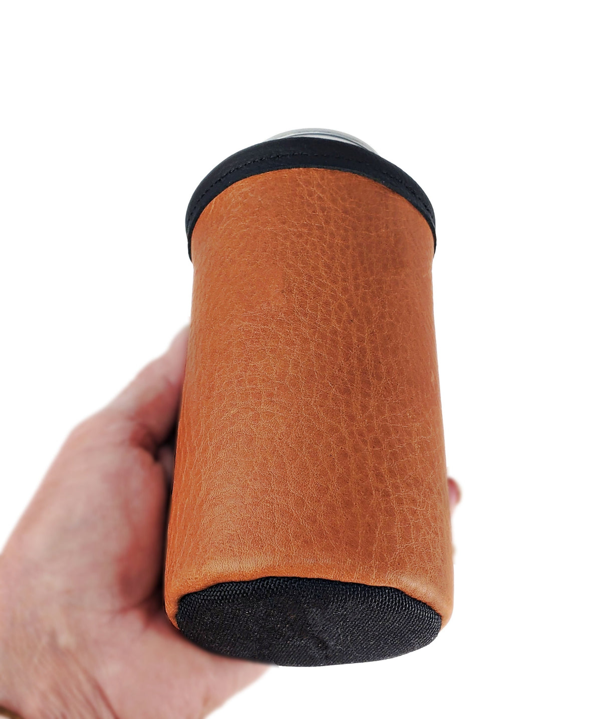 Saddle tan leather 16oz tall boy can cooler with black fabric bottom shown at an angle