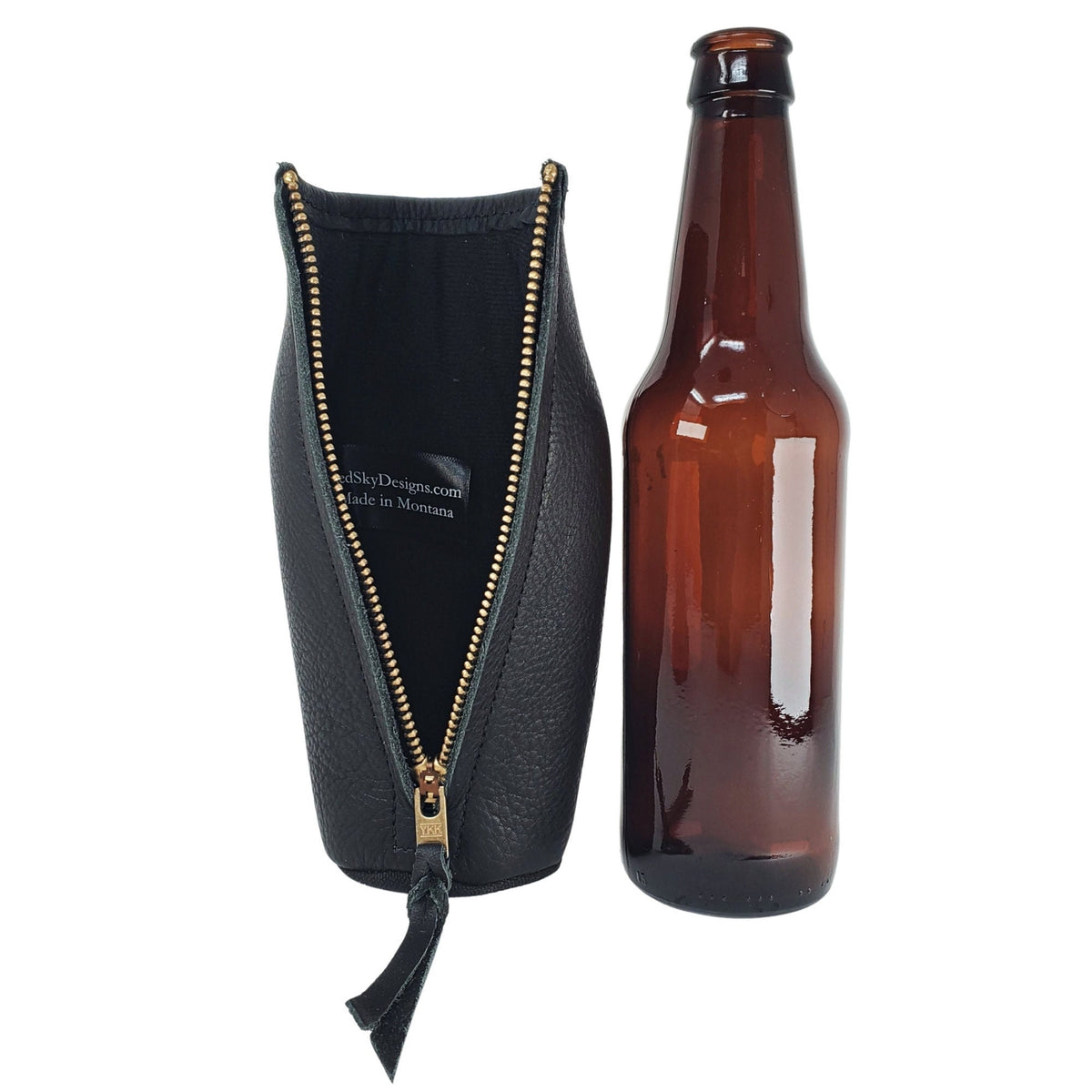 Black leather bottle holder unzipped beside a long-neck bottle, showing the insulated lining