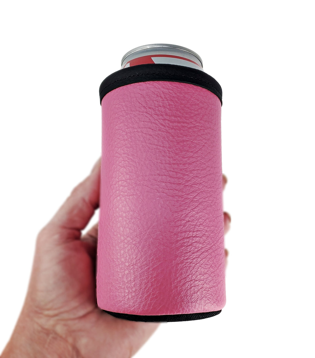 Pink smooth leather 16oz tall boy can holder with black trim around a beverage can, held in one hand