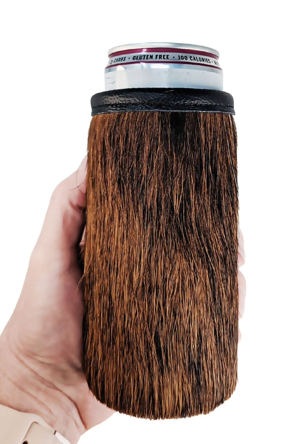 Hand holding a dark brown and black brindle hair-on cowhide 12oz slim can cooler