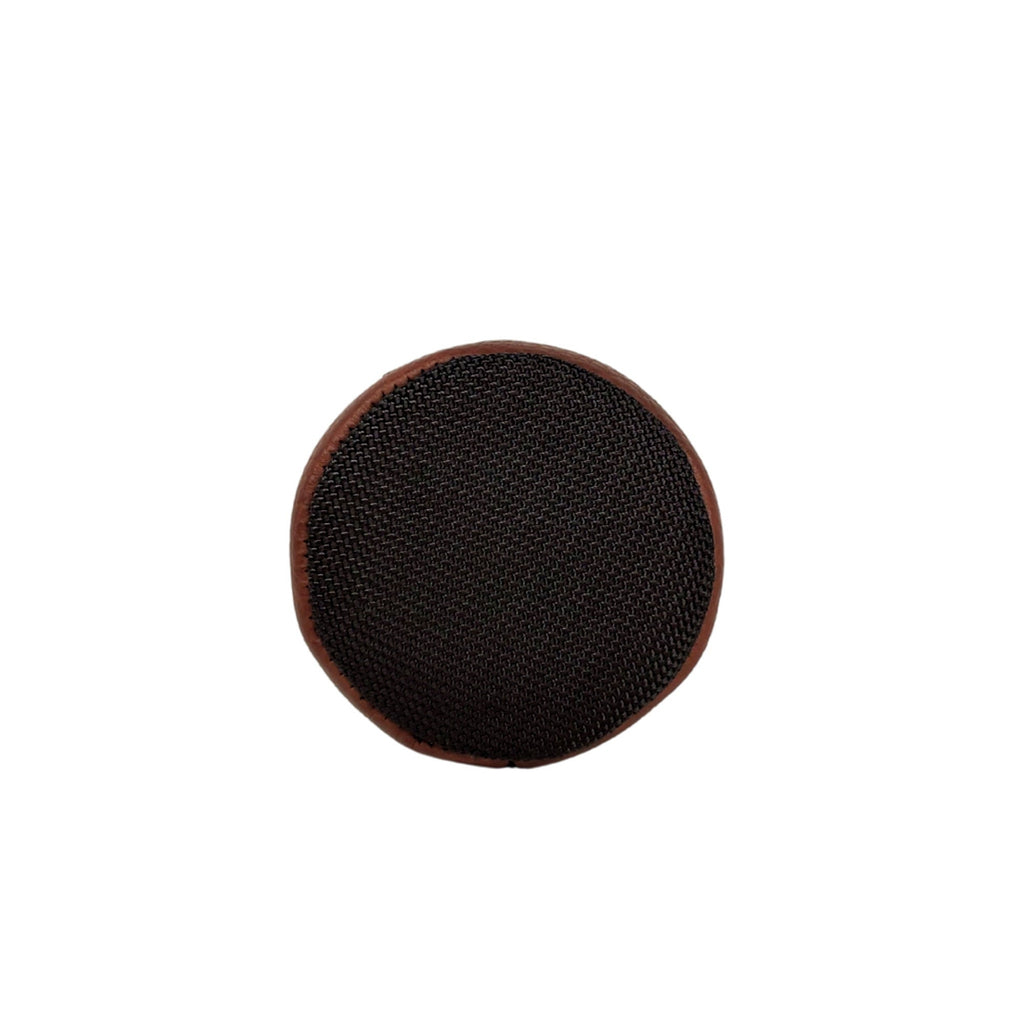 Close-up of the durable black ballistic nylon bottom of a brown leather slim can holder
