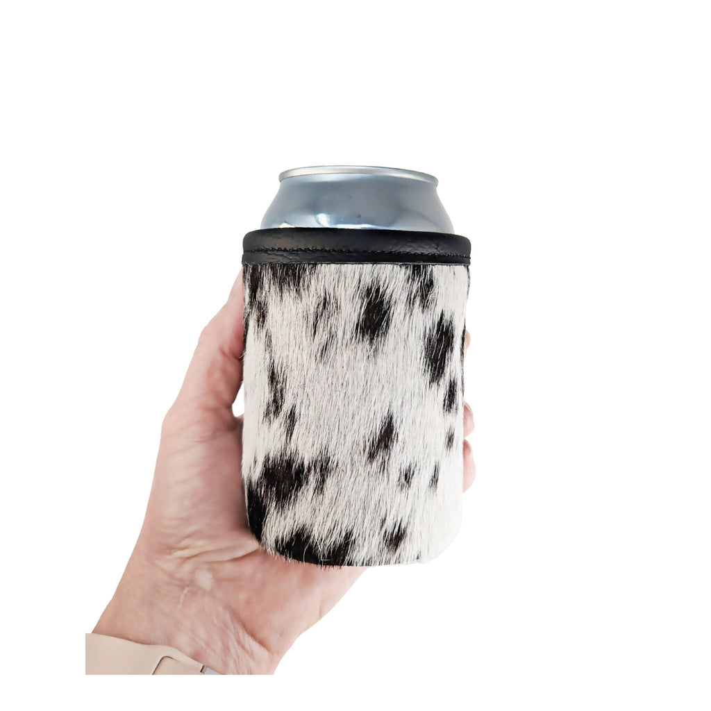 Black and white speckled cowhide can holder shown in hand