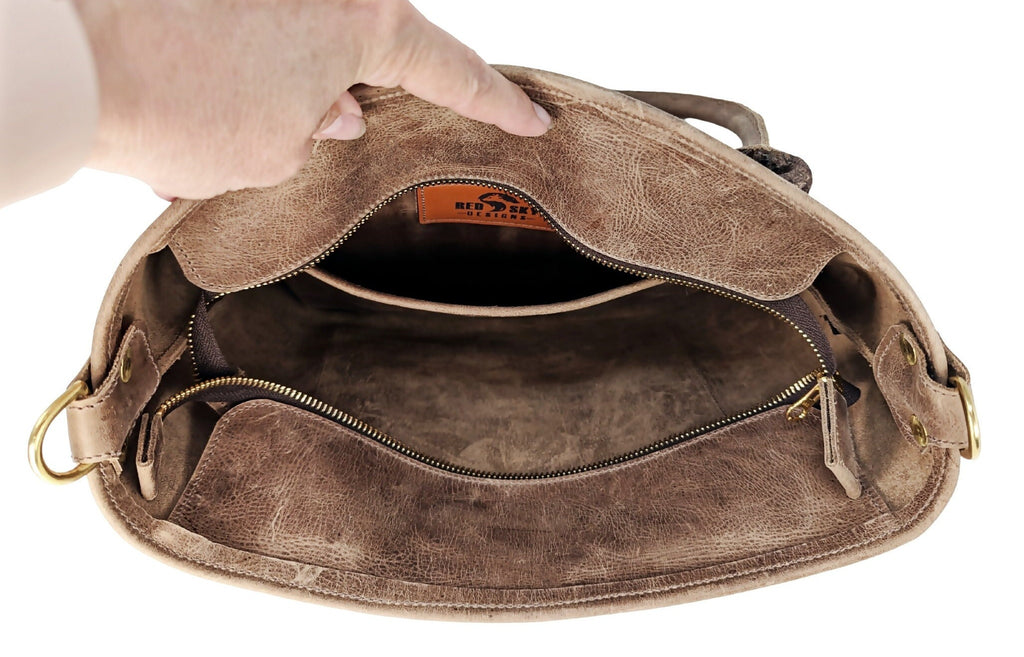 Open Madison distressed brown leather tote showing unlined interior, inner slip pocket, YKK zipper, and side D-rings