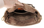 Open Madison distressed brown leather tote showing unlined interior, inner slip pocket, YKK zipper, and side D-rings