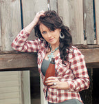 Woman holding a brown leather beer bottle holder outdoors