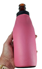 Hand holding a pink leather bottle holder on a long-neck bottle
