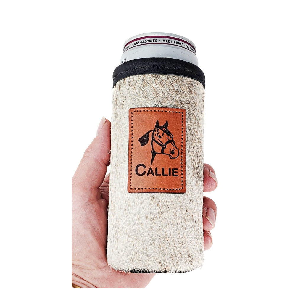 Light cowhide slim can holder engraved with a horse design and the name CALLIE, shown in hand