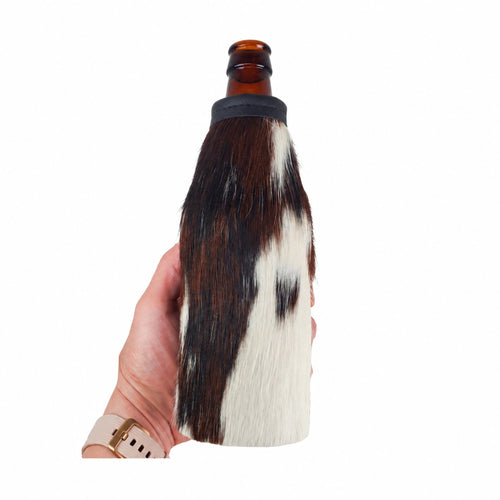 Tricolor cowhide beer bottle holder shown in hand for scale